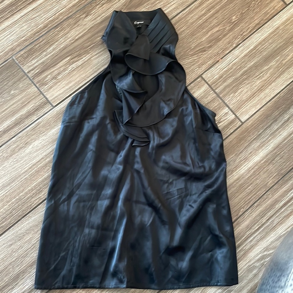 Cute black blouse that buttons on the front neck and shows some skin on chest